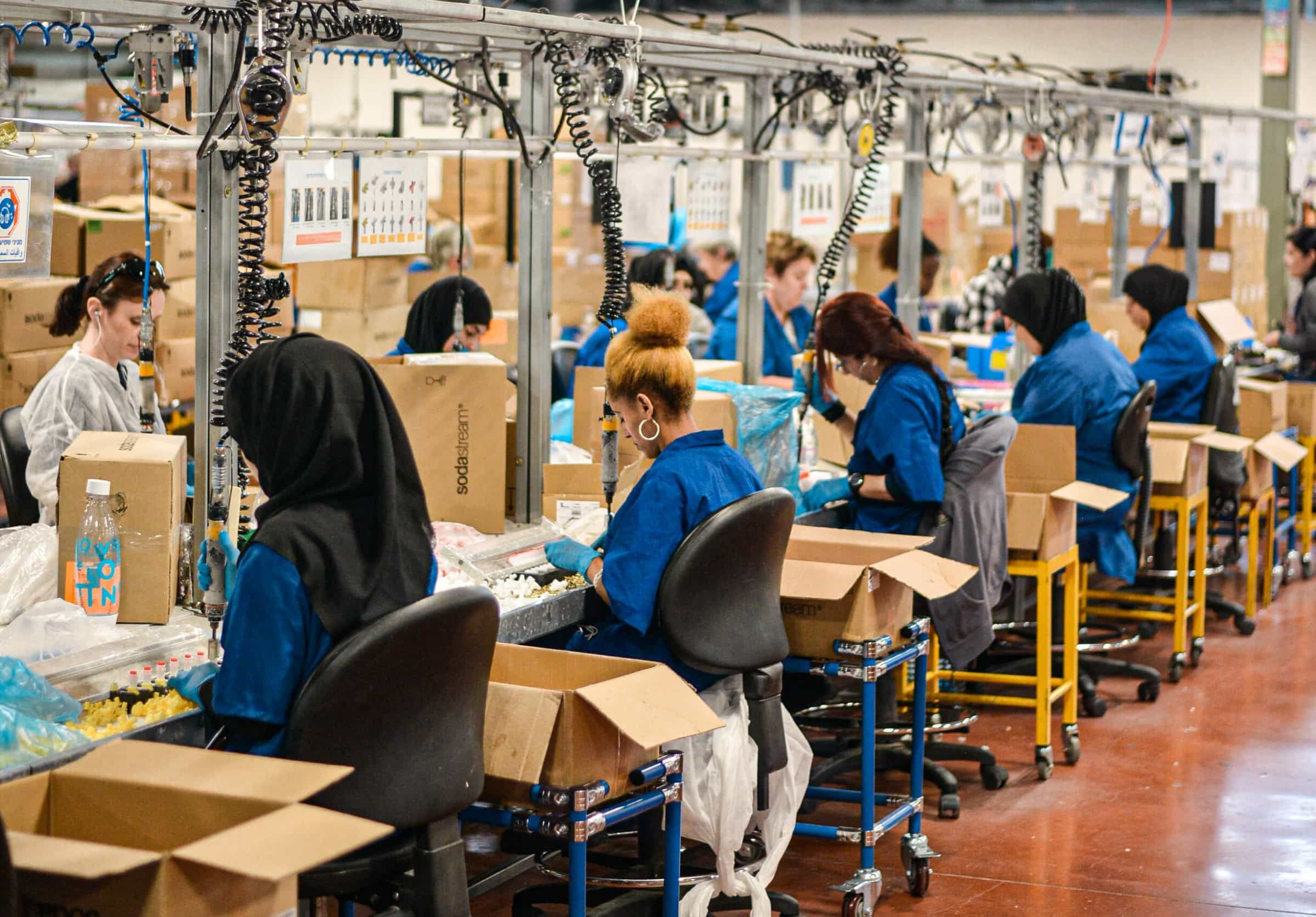 Women working on quality check at a factory.