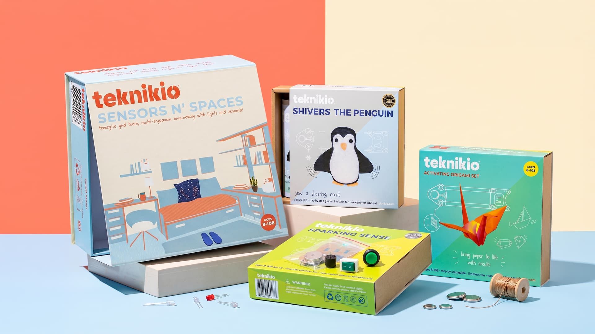 Four diverse Teknikio STEM educational kits displayed together, showcasing printed sleeves, trays, and interactive parts.