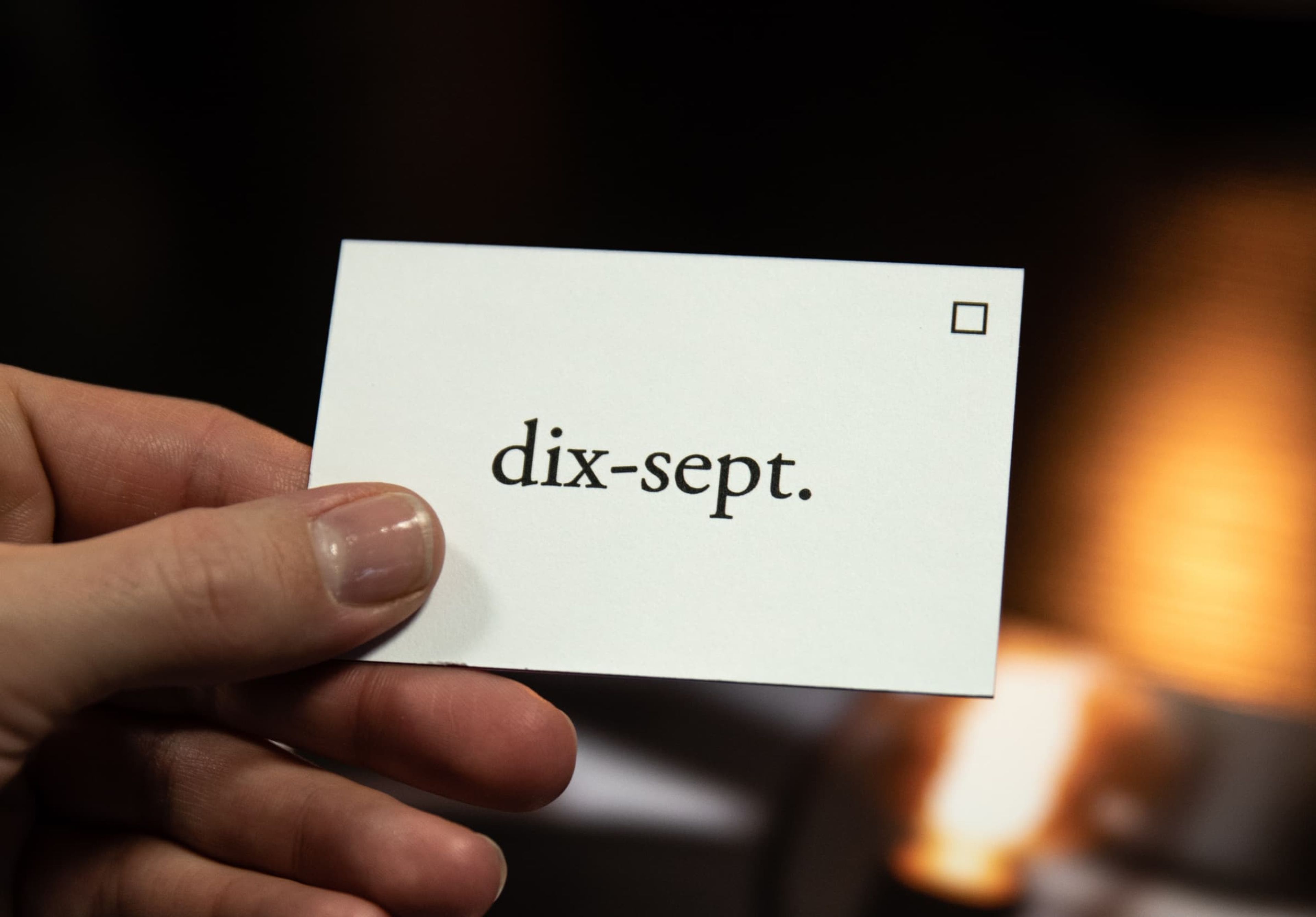 Hand holding a custom printed business card with aq coating.