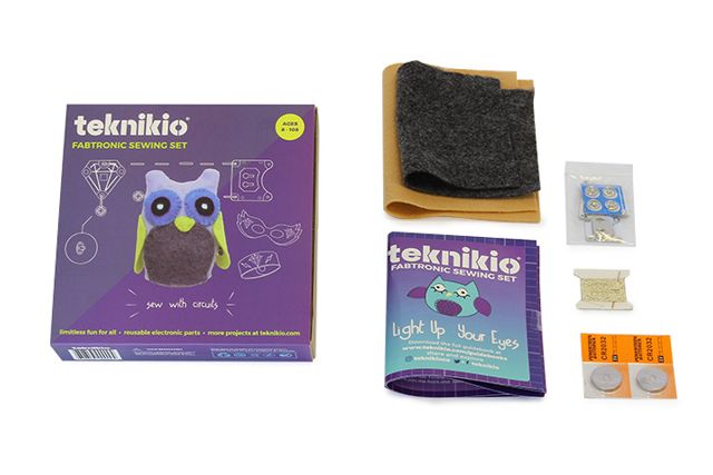 Teknikio Fabtronic Sewing Set box next to its contents, including felt, conductive thread, batteries, and a guidebook.
