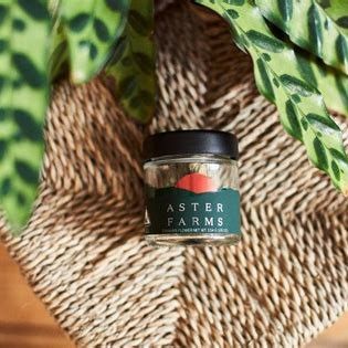 female hand grabbing an edible from a jar