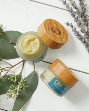 female hand grabbing an edible from a jar