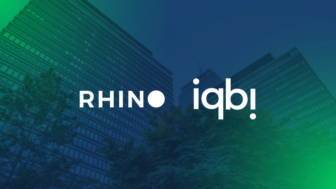Rhino and iqbi logos over an office building, marking 20 million monthly data points