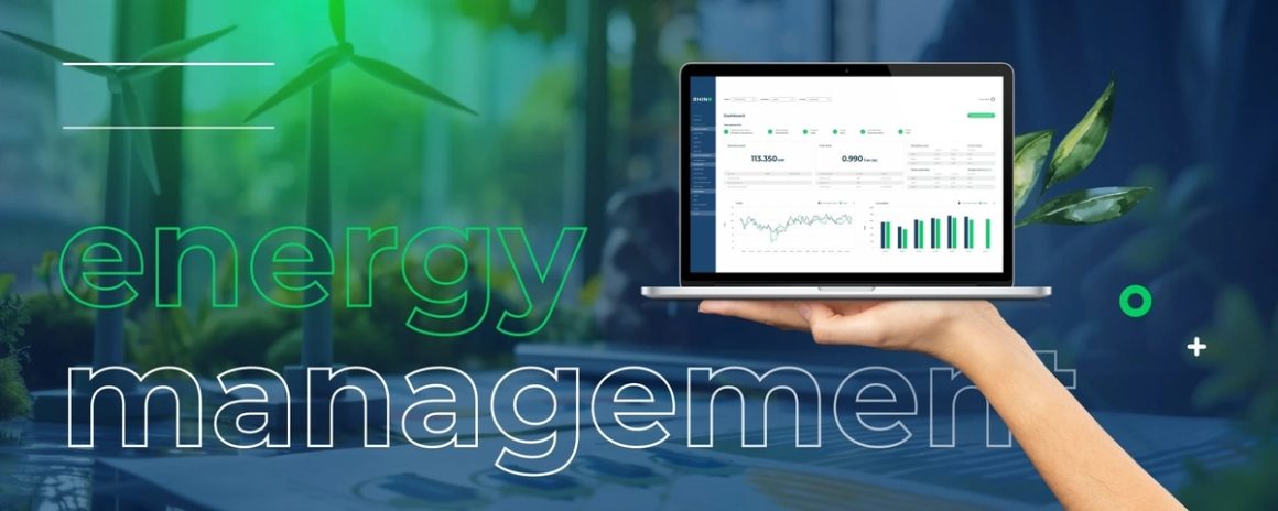 Energy management dashboard on a laptop, with wind turbines in the background