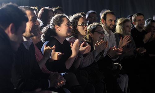 Image of people laughing in a comedy venue