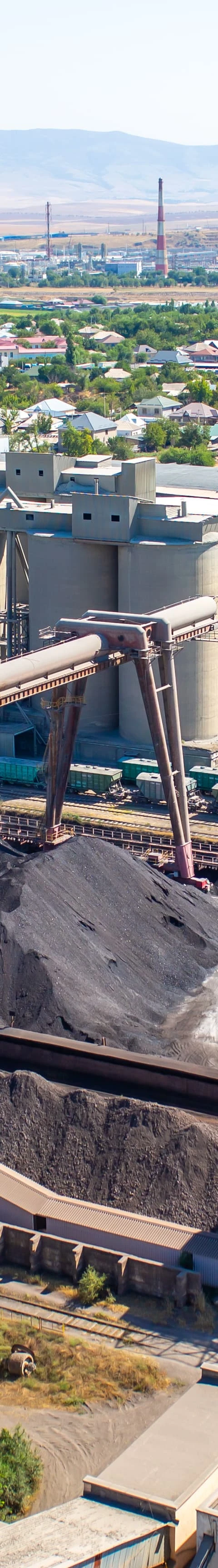 people discussing insurance with model house in the background and calculater in front