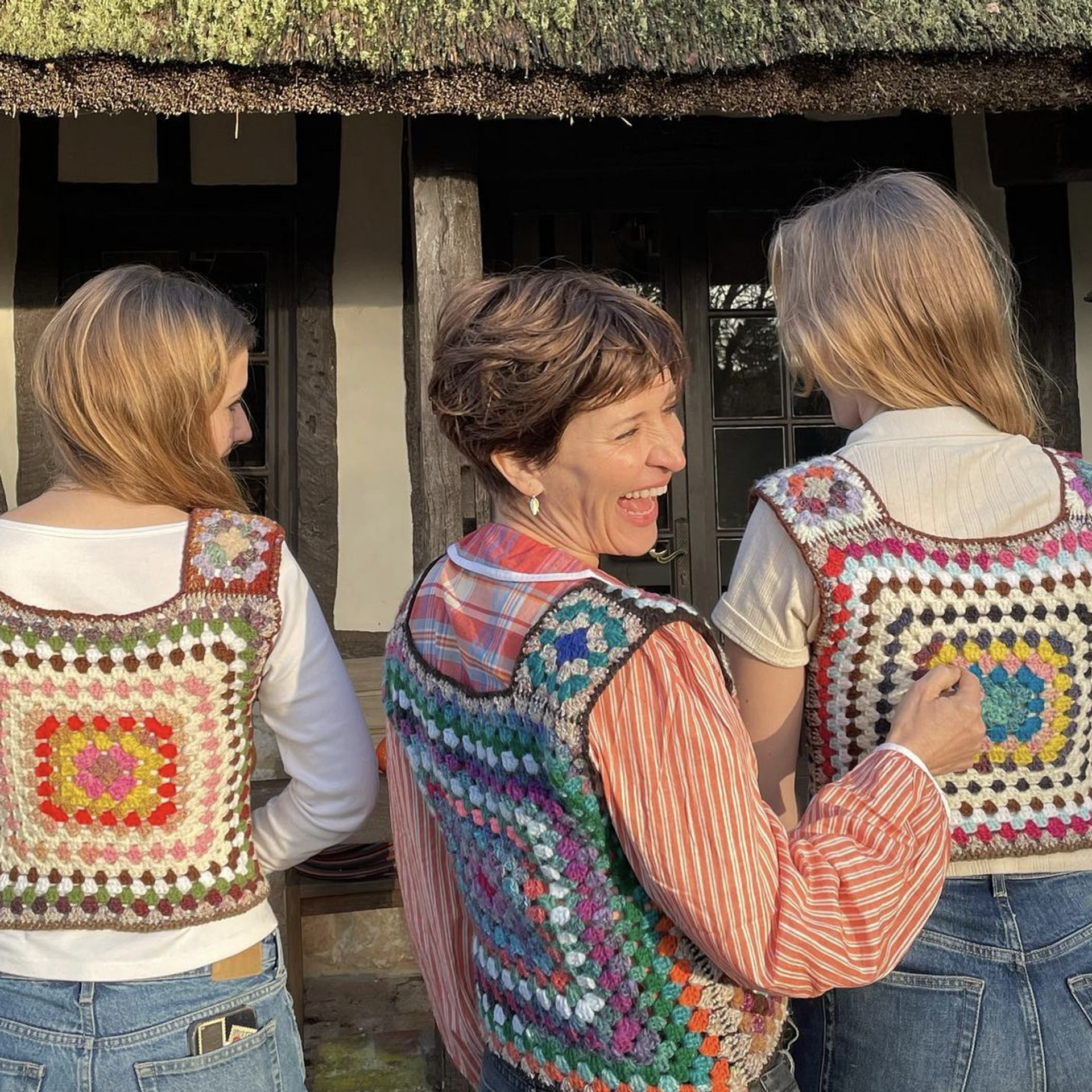 three people wearing crochet vests