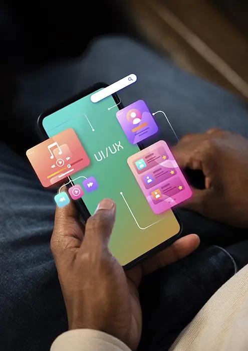 Close-up of hands holding a smartphone with a vibrant UI/UX design interface displayed on screen, showcasing icons for music, messaging, and settings, emphasizing modern app development 