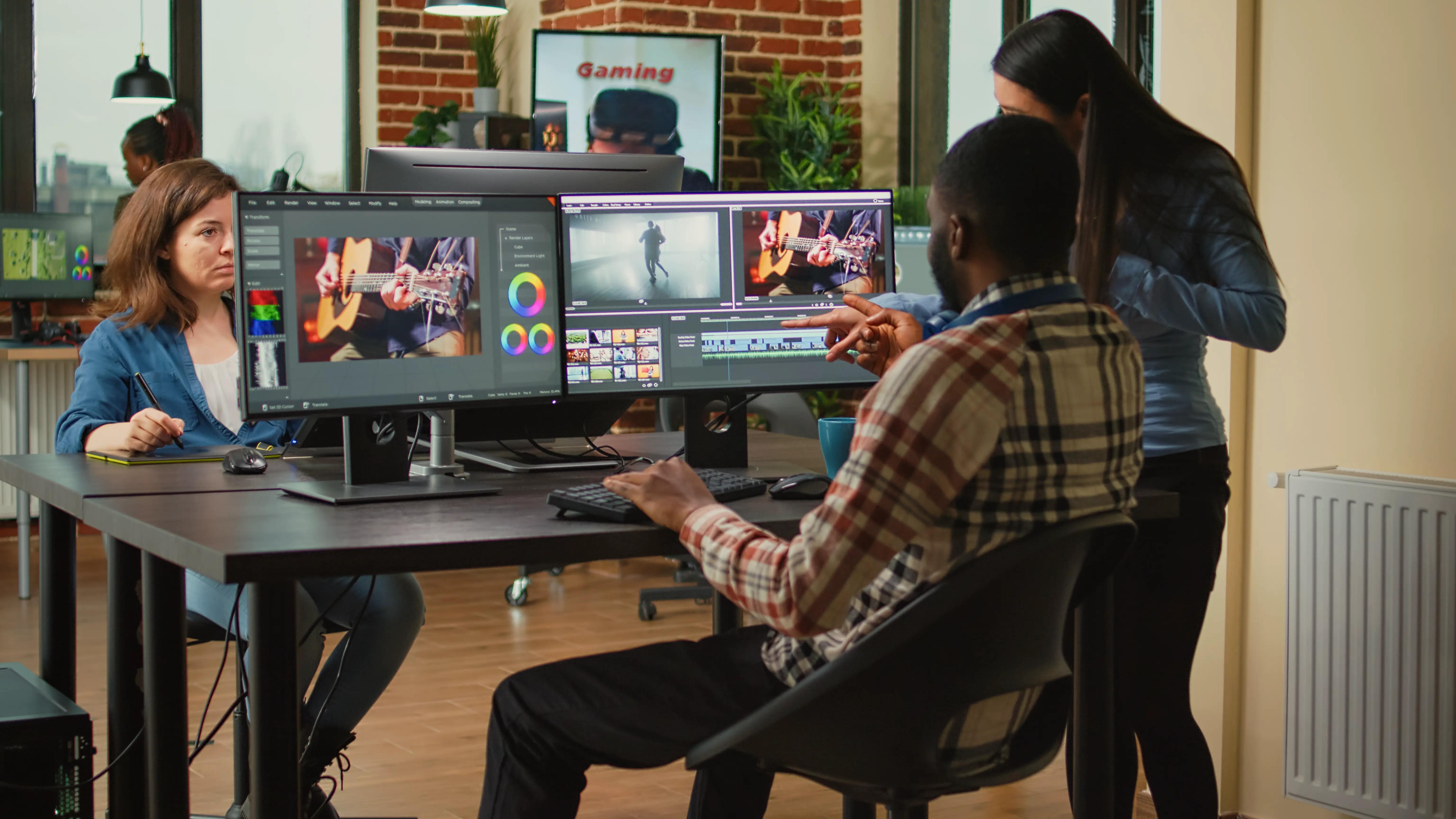 Dedicated team of content creators collaborating on movie montage using advanced editing software, discussing ideas to enhance video focus and lighting, in a dynamic studio environment, showcasing the synergy of audio-visual post-production teamwork.