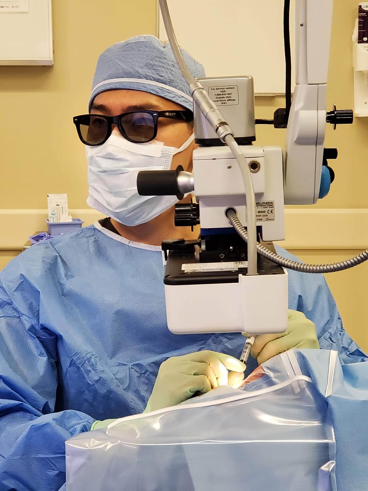 Dr. Joseph Ling using a surgical microscope