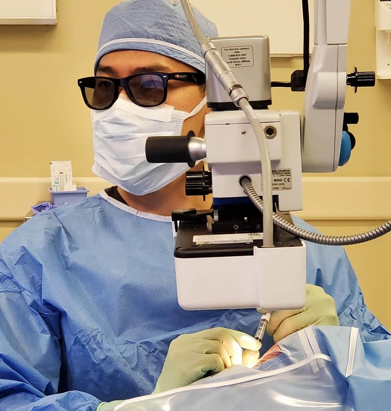 Dr. Joseph Ling using a surgical microscope