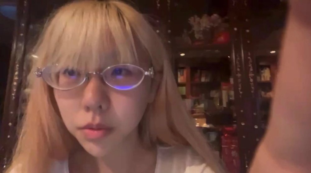 Lotus Y. wearing glasses before her procedure