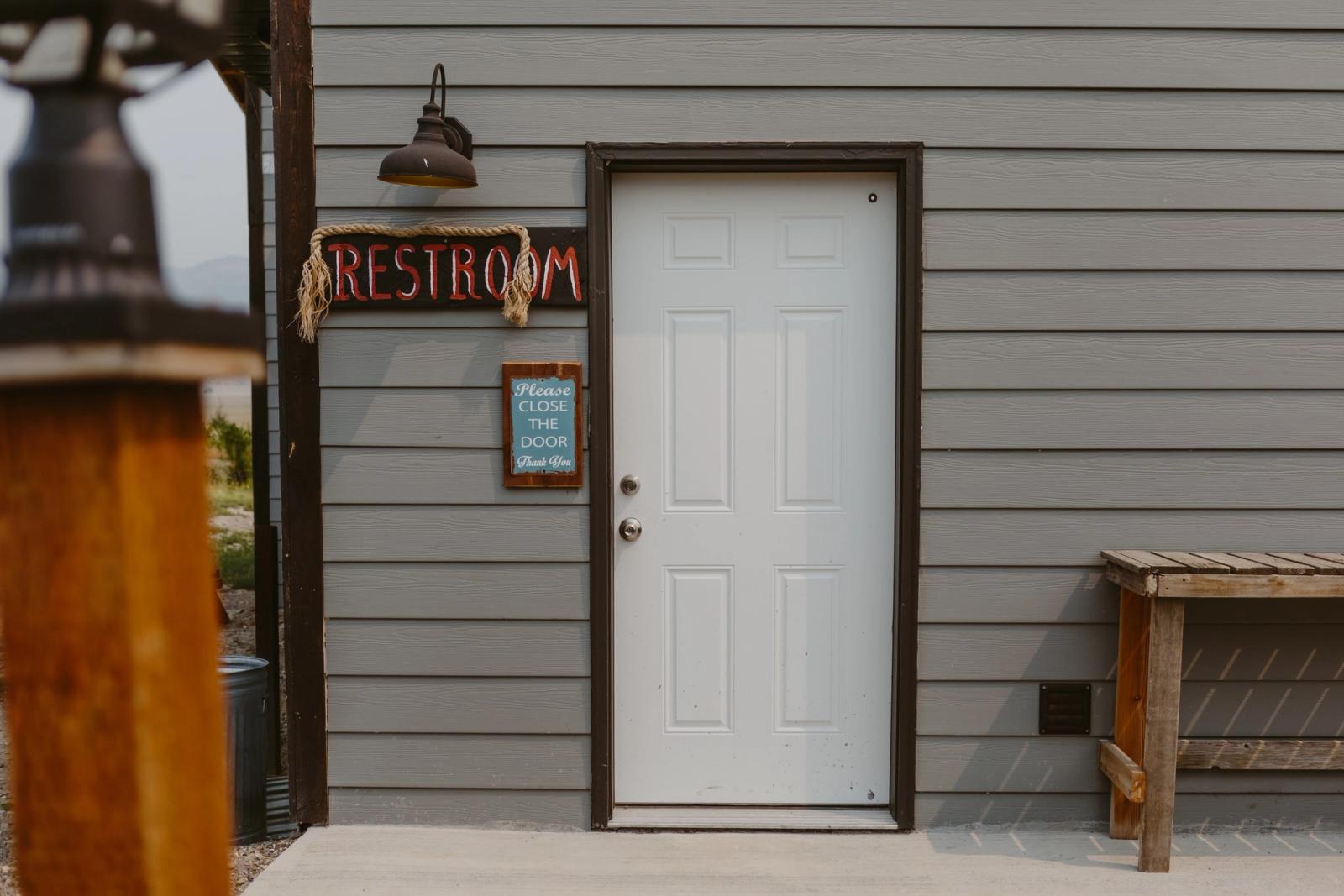 The farm's guest restroom, with a hand-painted RESTROOM sign over the door