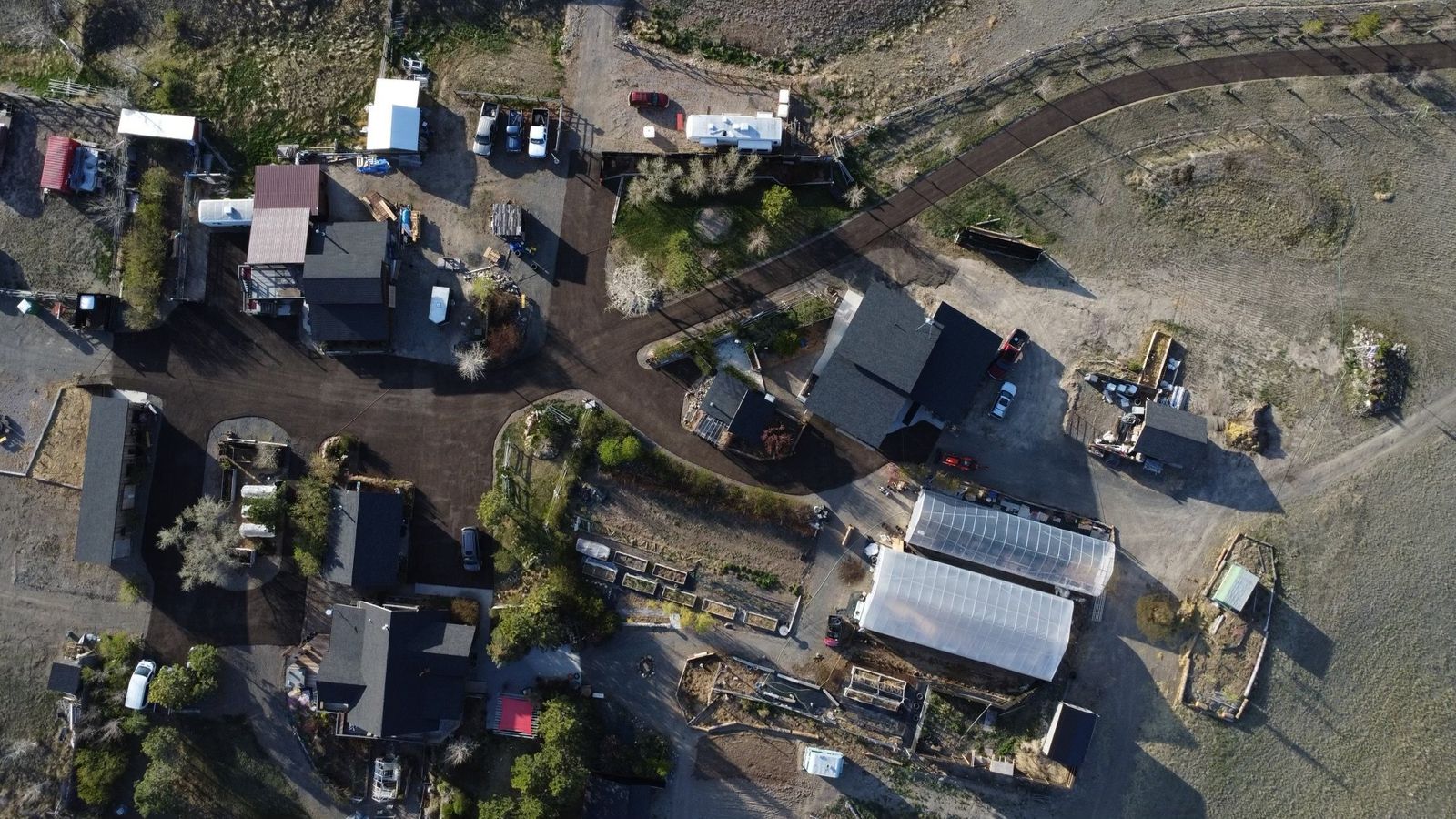 Looking straight down on the farmyard, the barns and the gravel lot from above