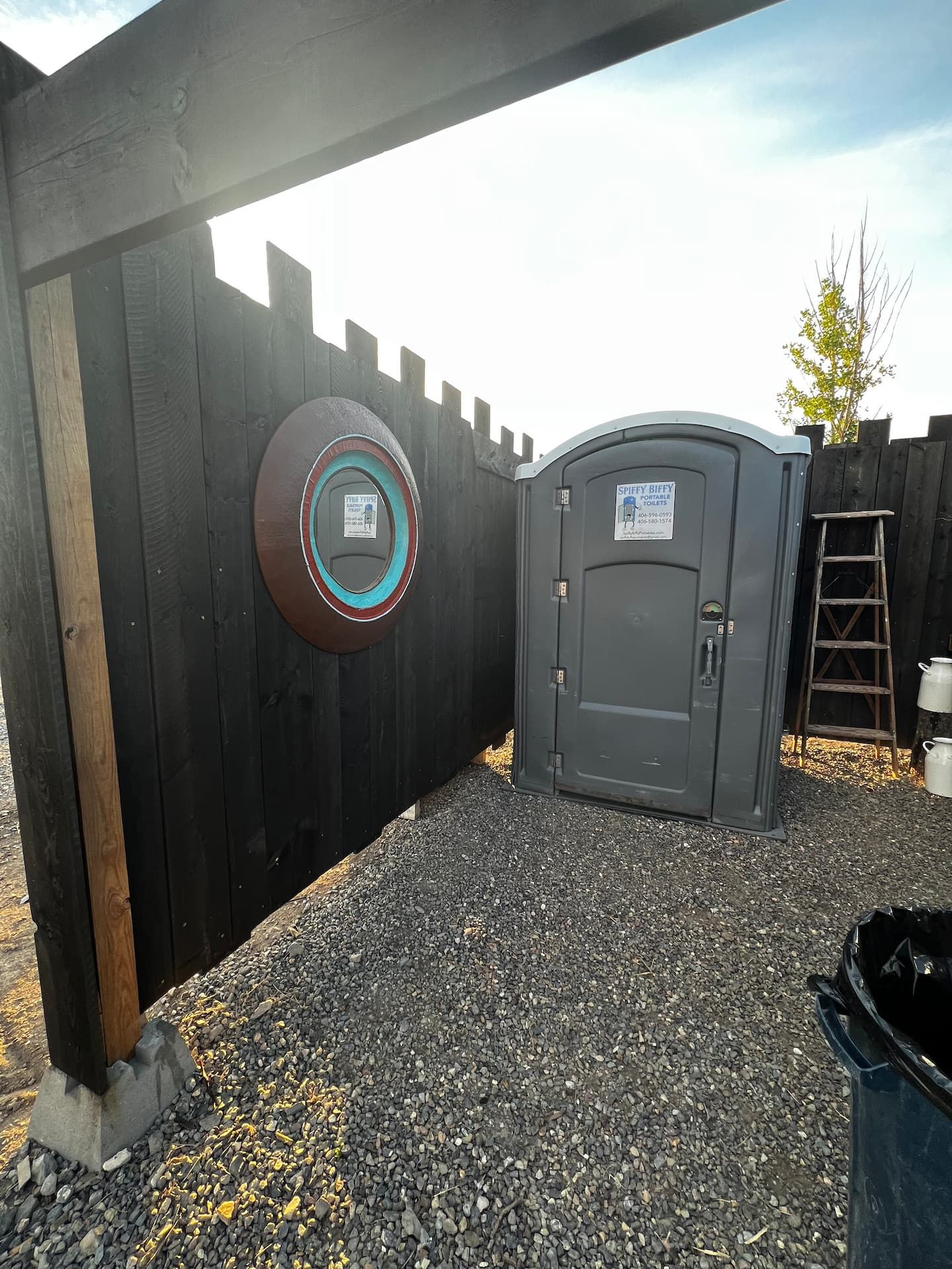 Private outdoor restroom area behind the cedar fence