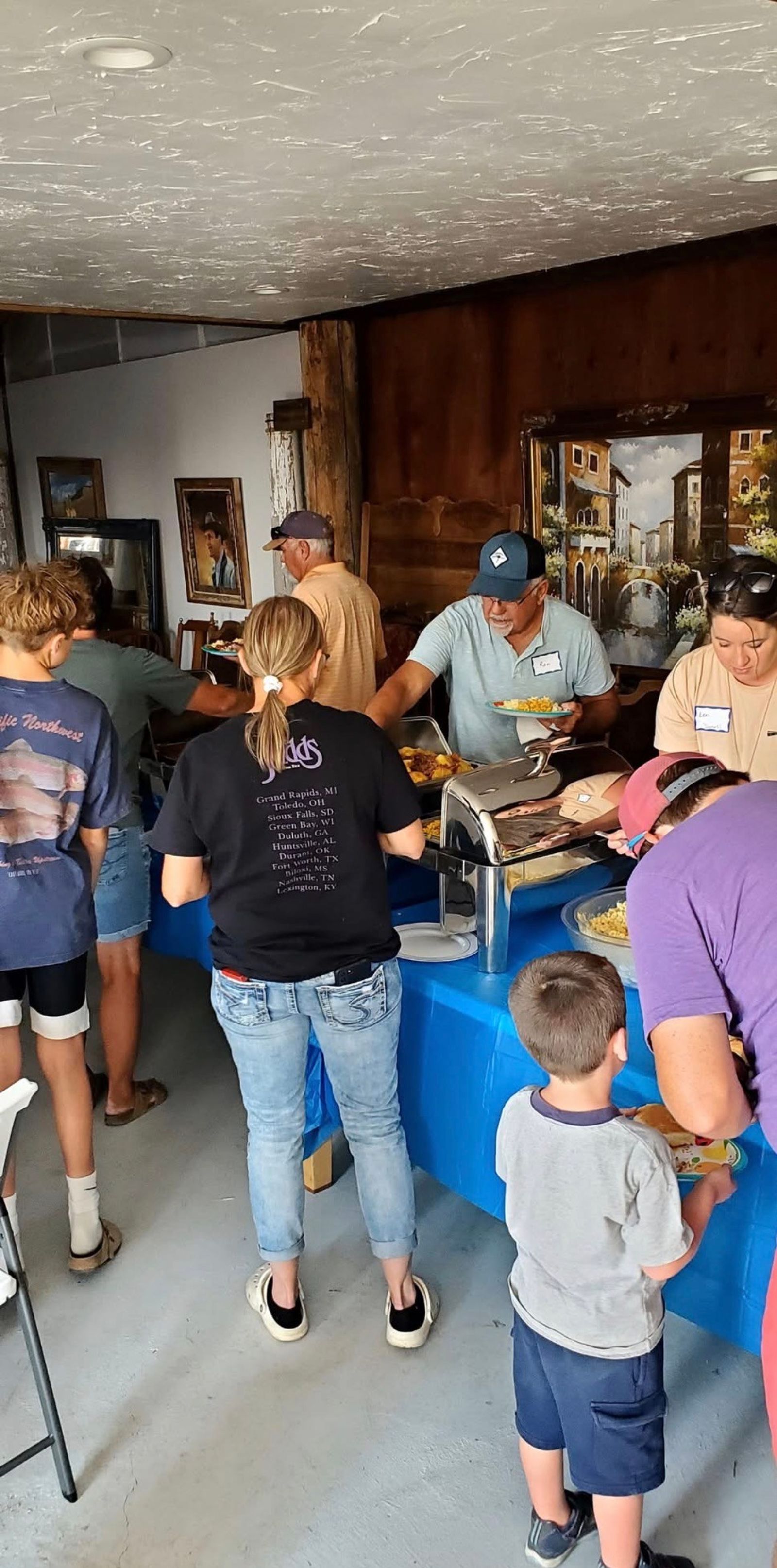 Guests filling their plates at the buffet inside the Bourbon Barn