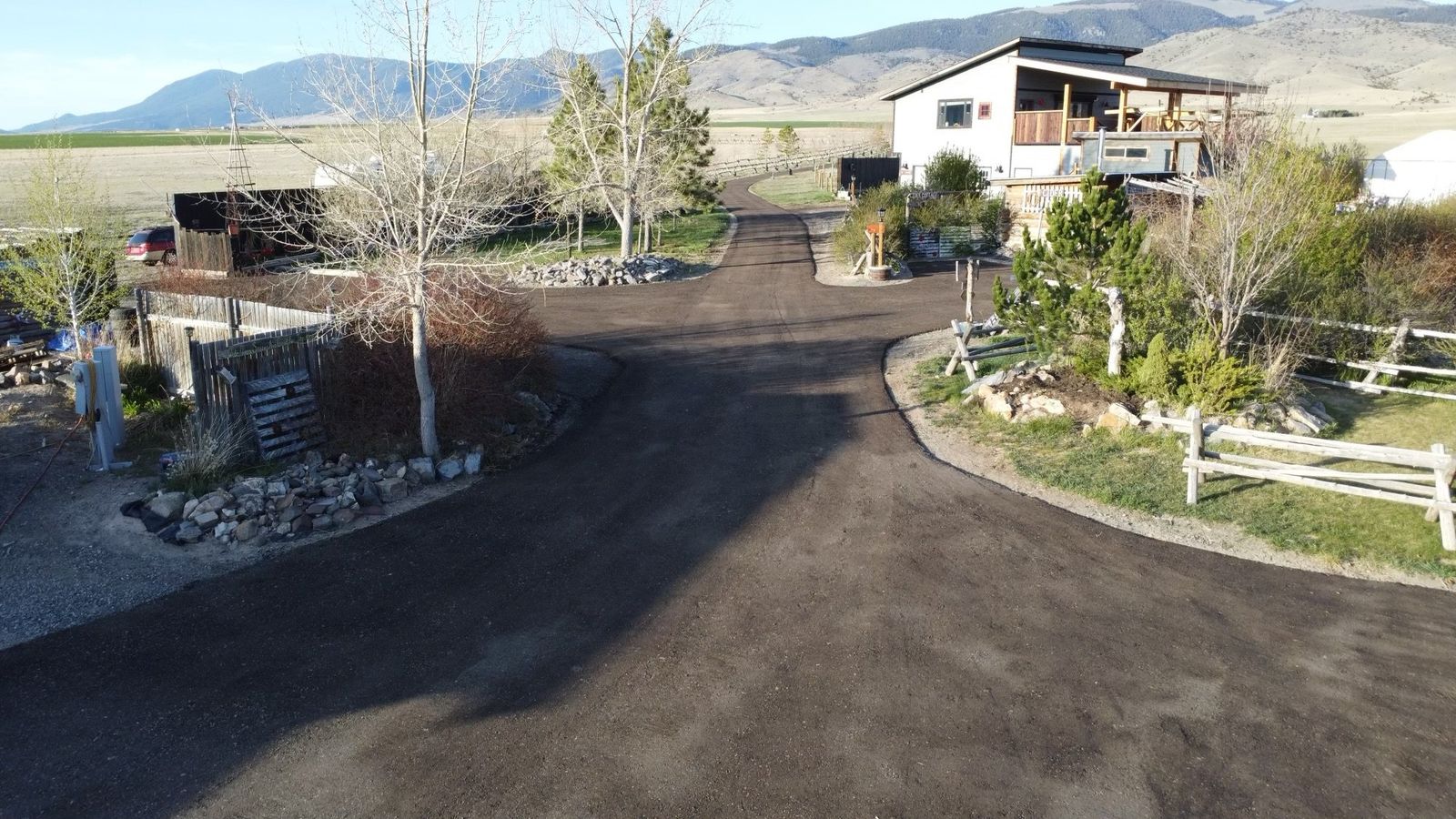 The circle drive and gardens in front of the farmhouse, seen from above