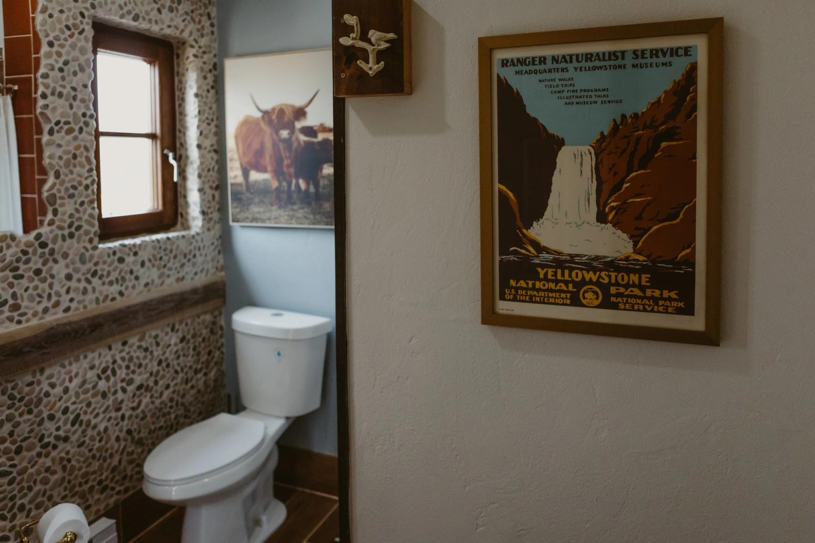 The guest restroom, with a vintage Yellowstone poster on the wall