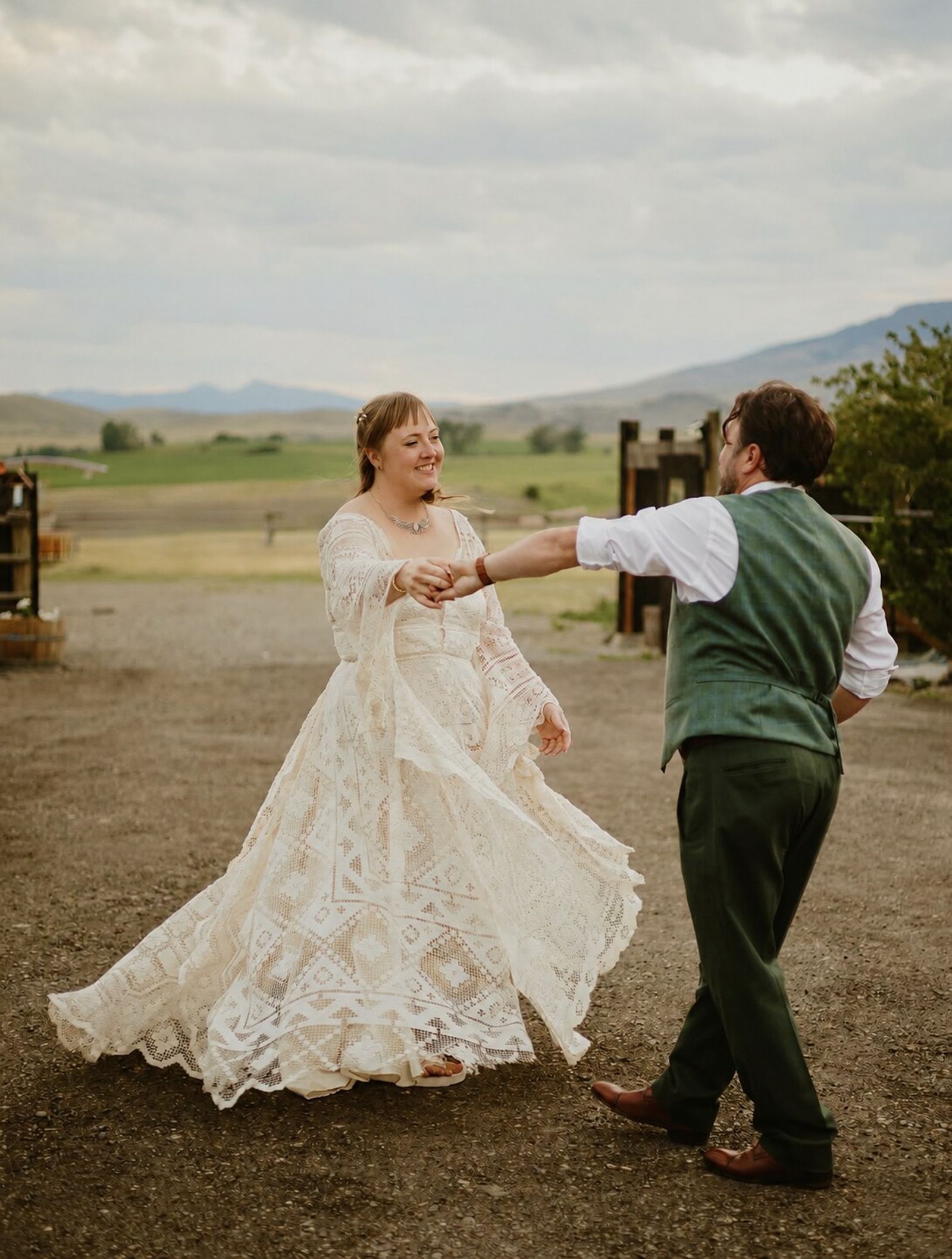 Couple dancing on the farm road with the valley behind them