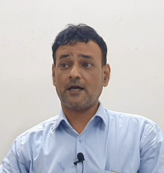 Author Sayed Minhal in blue shirt