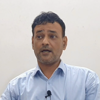 Author Sayed Minhal in blue shirt