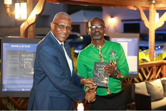 Sir Rodney Receives Signed Copy of Robinson’s Book on Caribbean Survival