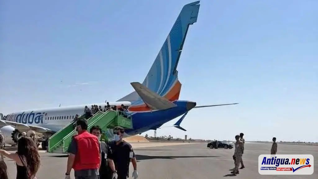 Passengers are seen leaving a flydubai aircraft on the tarmac at Tabuk Airport in Saudi Arabia following an emergency diversion. The flight had been travelling from Dubai to Tel Aviv when a serious security incident was reported onboard.