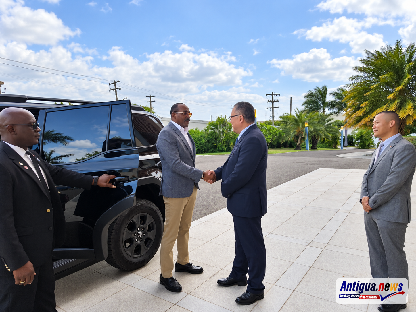 Prime Minister Gaston Browne is greeted by Zhang Peng, Charge d' Affairs of the Chinese Embassy in Antigua and Barbuda