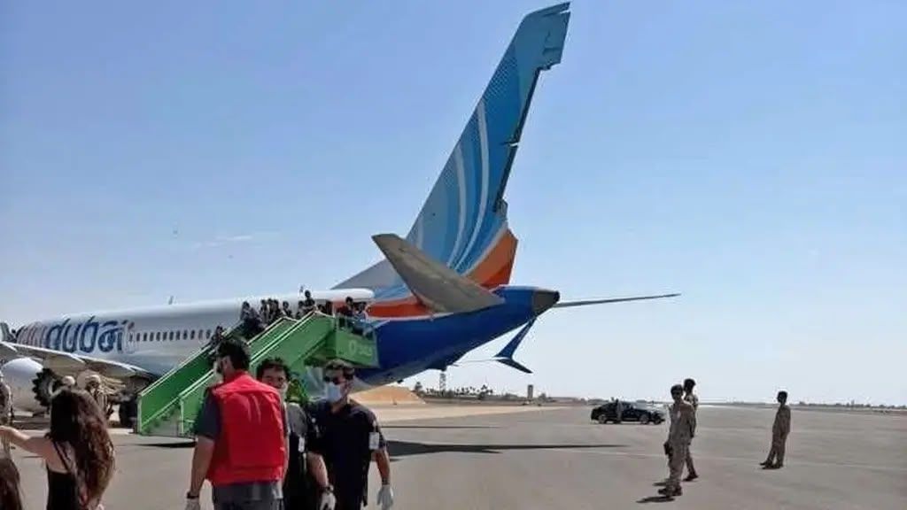 Passengers are seen leaving a flydubai aircraft on the tarmac at Tabuk Airport in Saudi Arabia following an emergency diversion. The flight had been travelling from Dubai to Tel Aviv when a serious security incident was reported onboard.