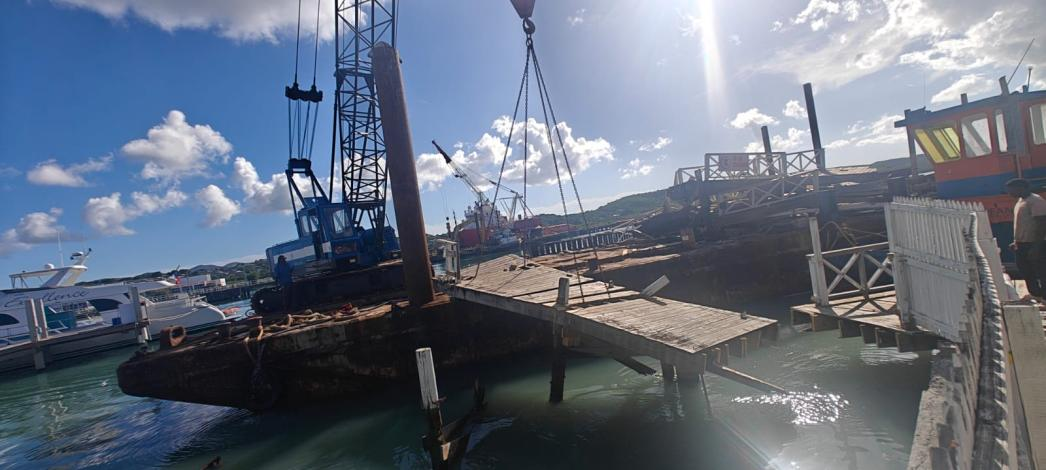 A crane positioned alongside the St. John’s waterfront boardwalk as rehabilitation works begin.