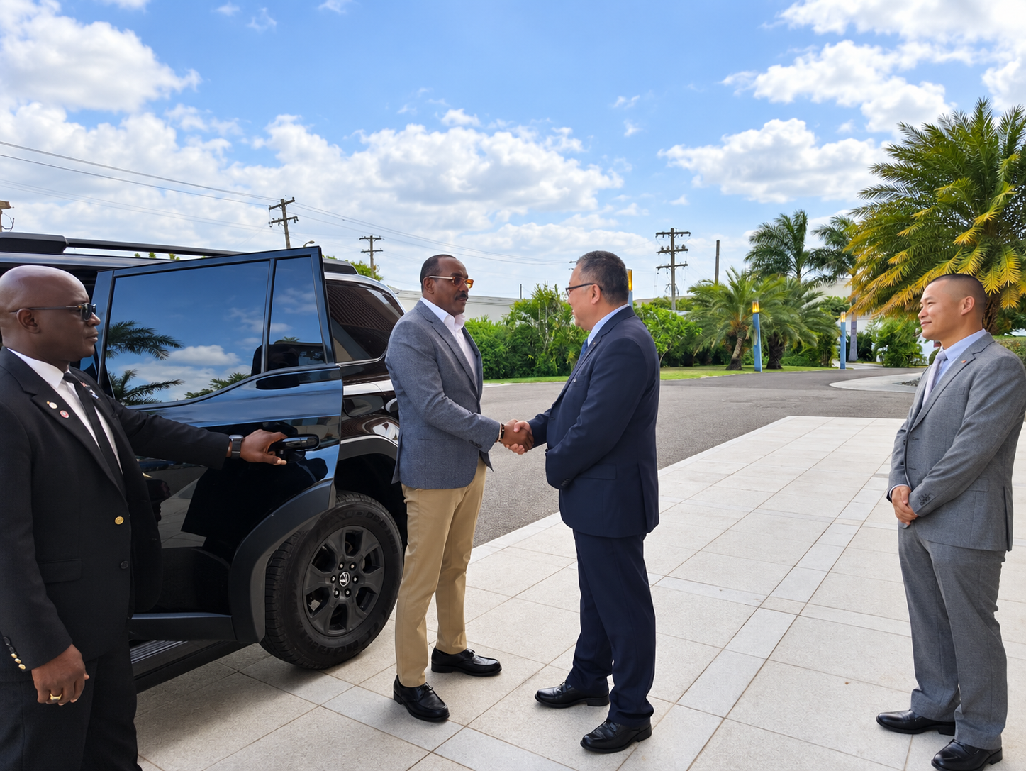 Prime Minister Gaston Browne is greeted by Zhang Peng, Charge d' Affairs of the Chinese Embassy in Antigua and Barbuda