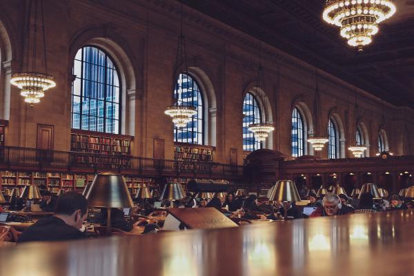Readers seated in the New York Public Library