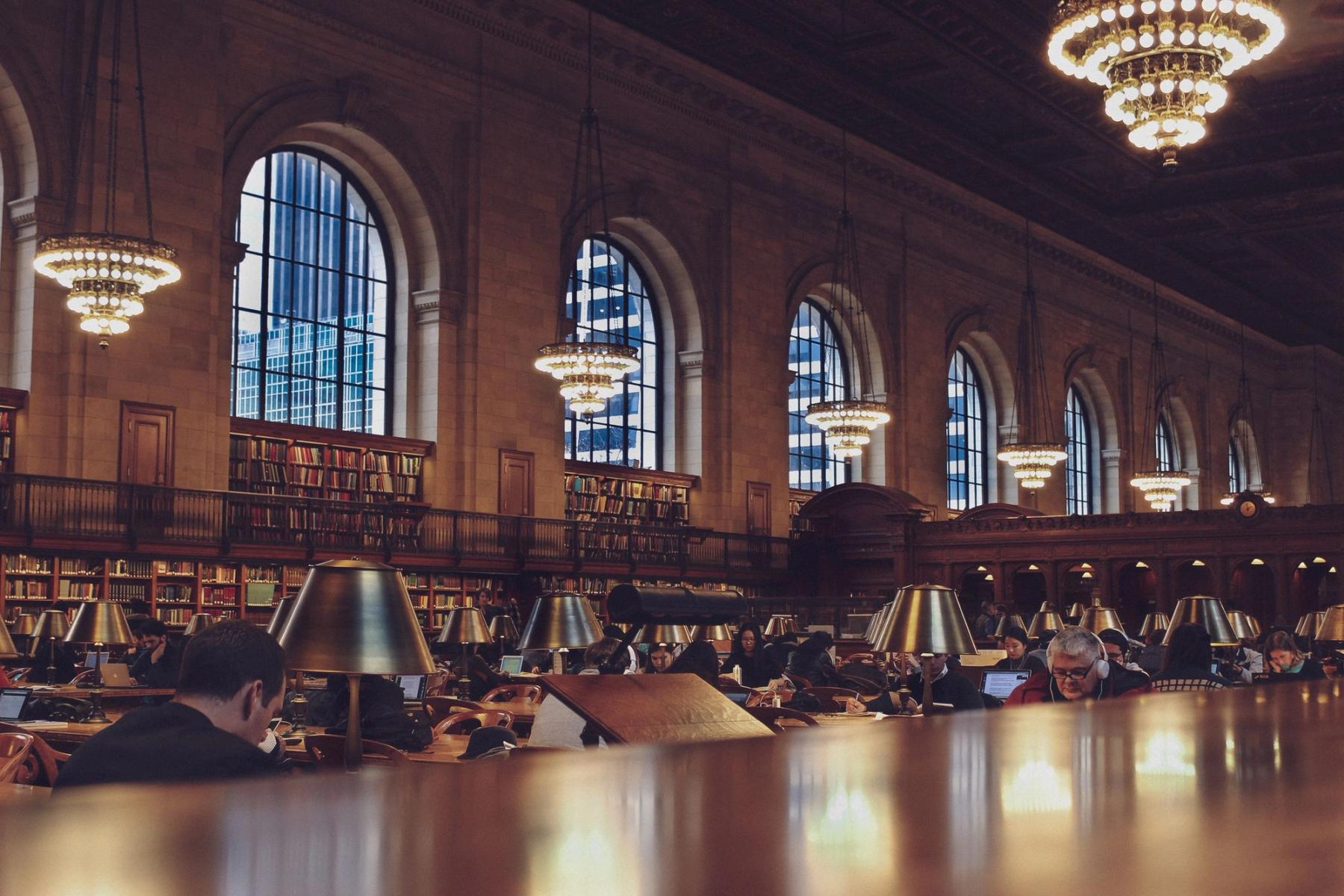 Readers seated in the New York Public Library
