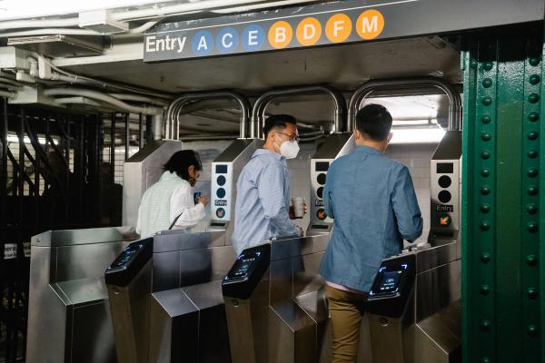 Commuters at New York subway turnstiles