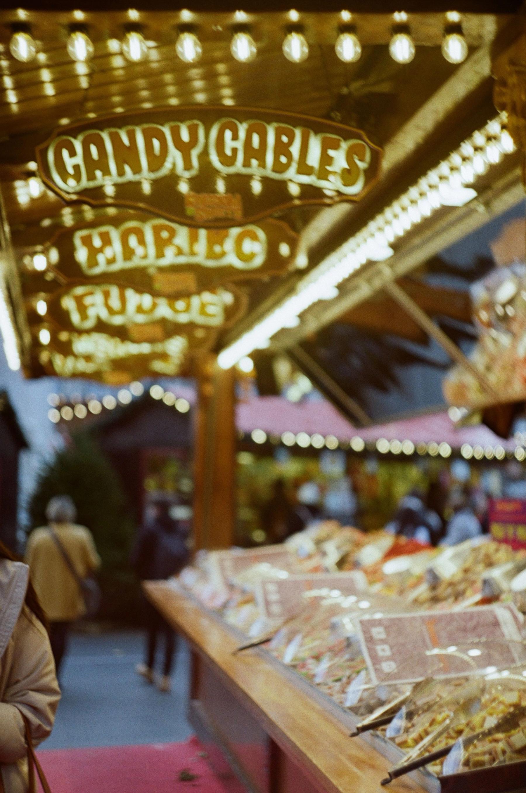 People beneath lights at a London street market