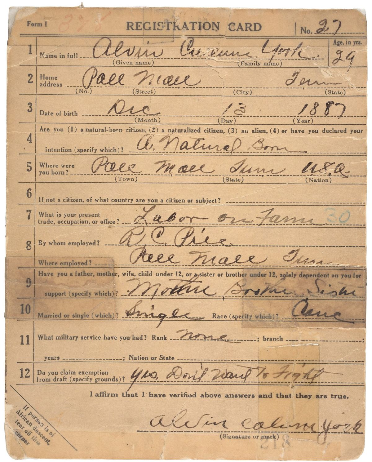 A faded World War I draft registration card filled in by hand, with the name, age 29 and a December 13, 1887 birth date at the top and a handwritten exemption claim near the bottom.