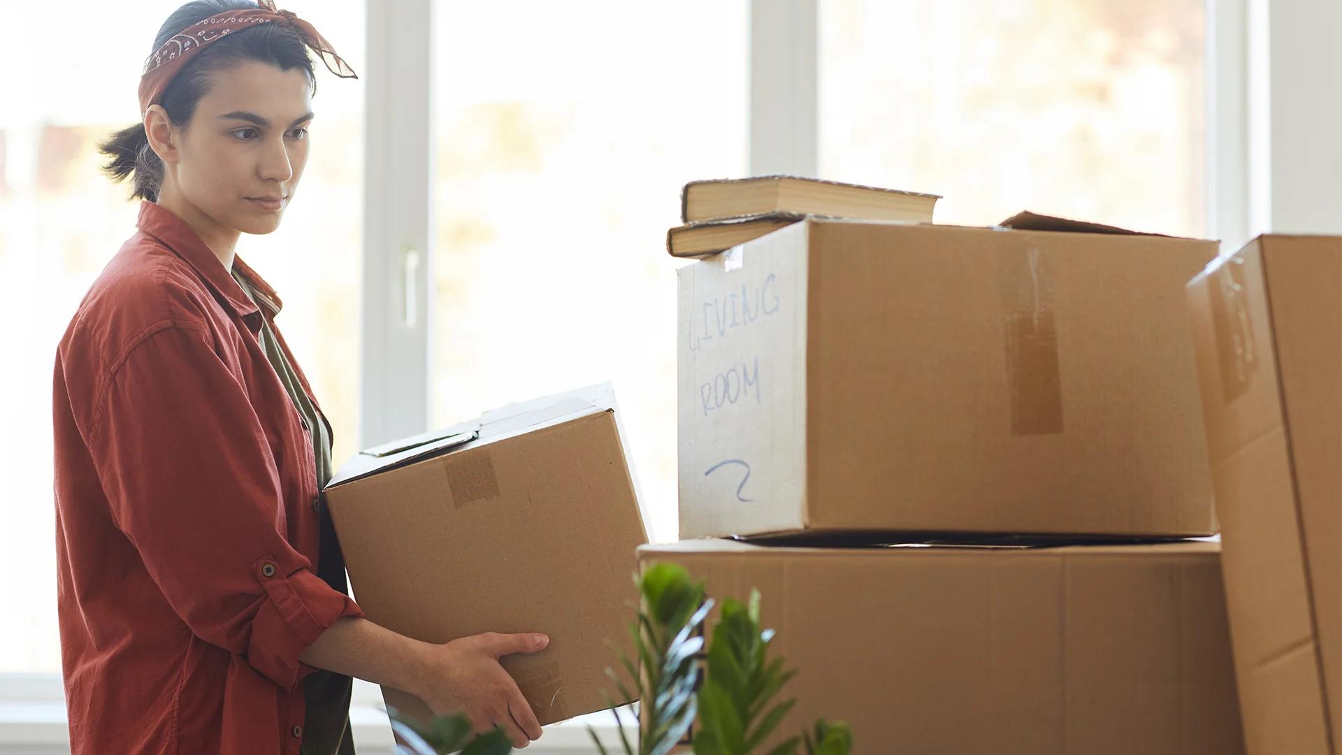 Young woman carrying box