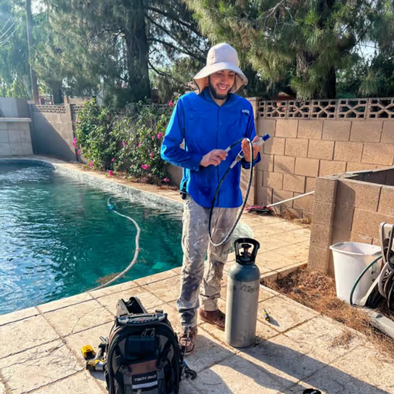 Pool technician doing performing leak detection service