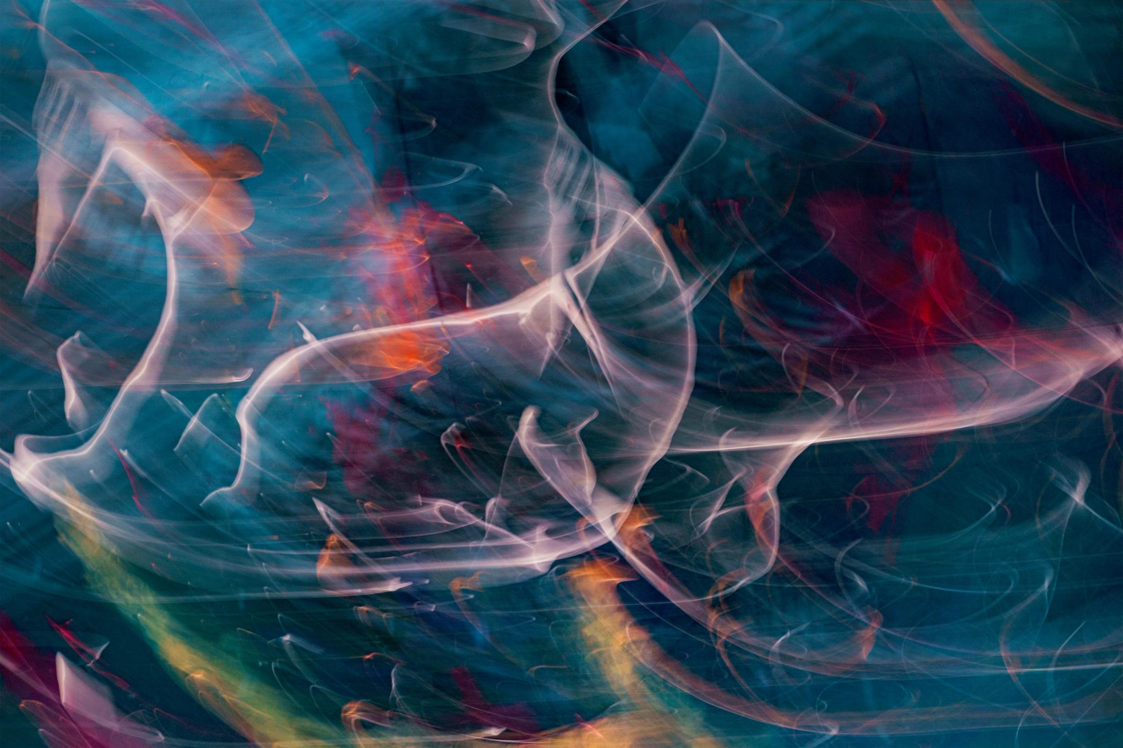 Abstract swirls of blue, red, orange and white light resembling thoughts, emotions and the unknown.