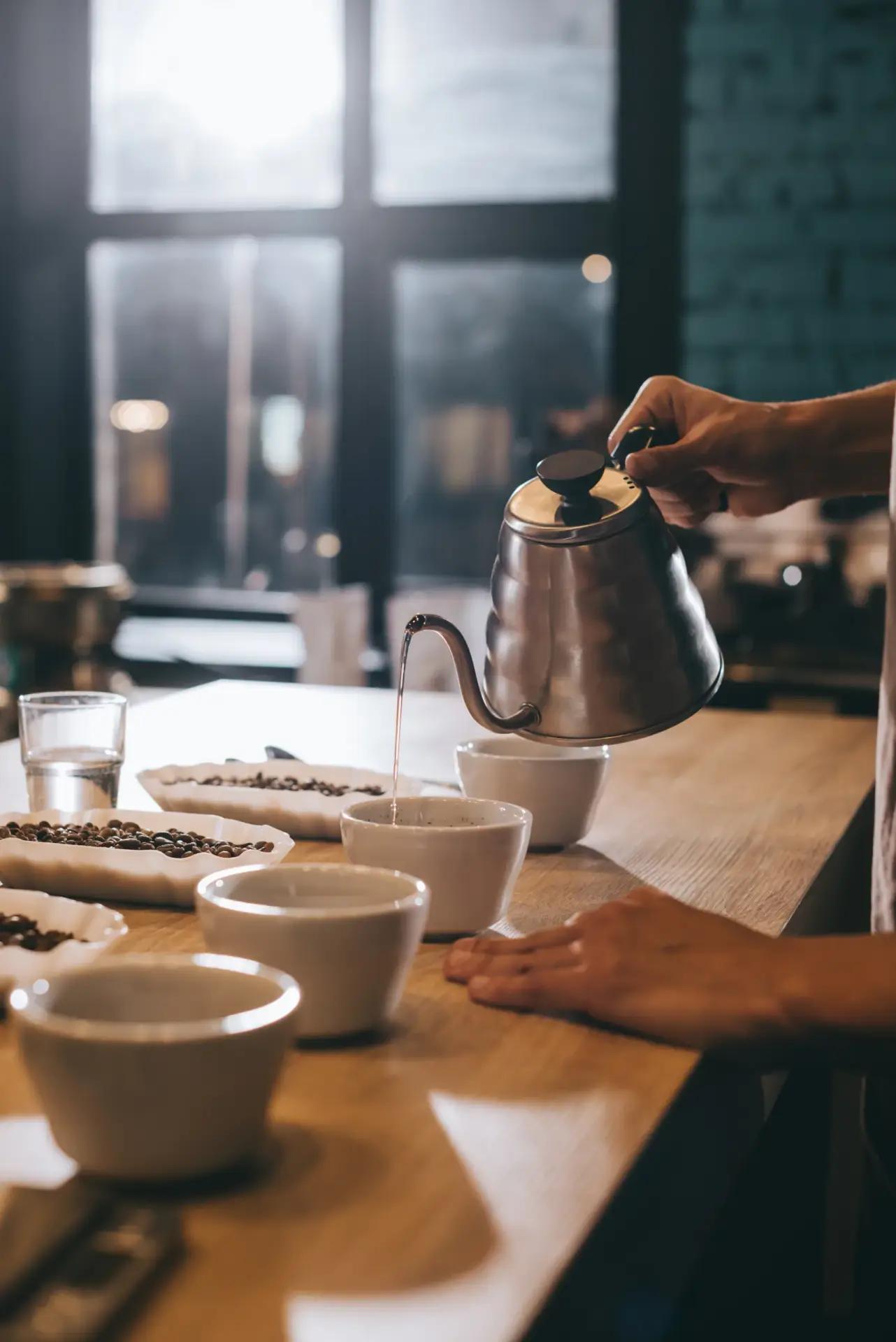 Pouring and preparing coffee for cupping during a training session