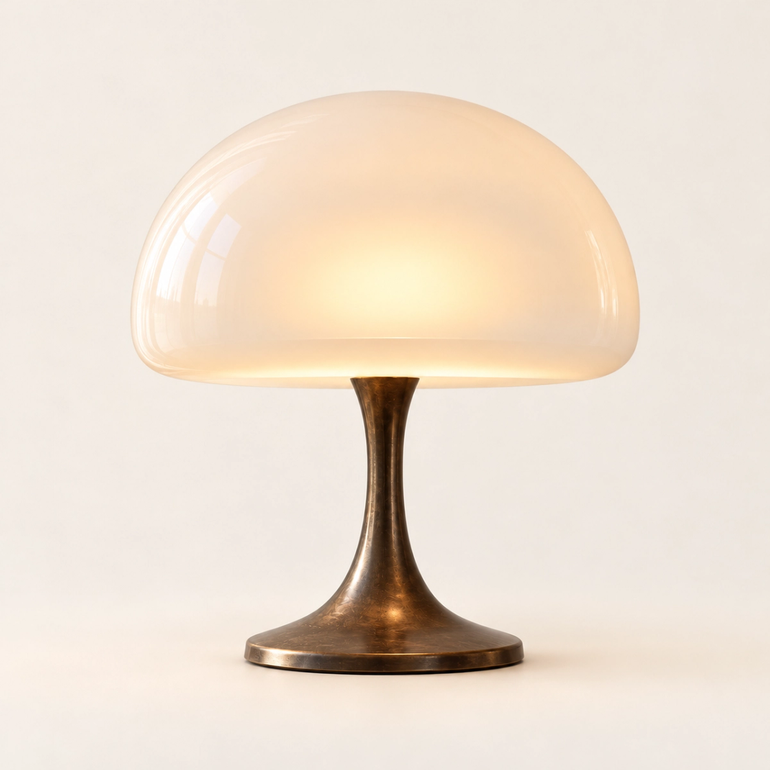 Opal dome lamp with a bronze base on a plain warm white background.