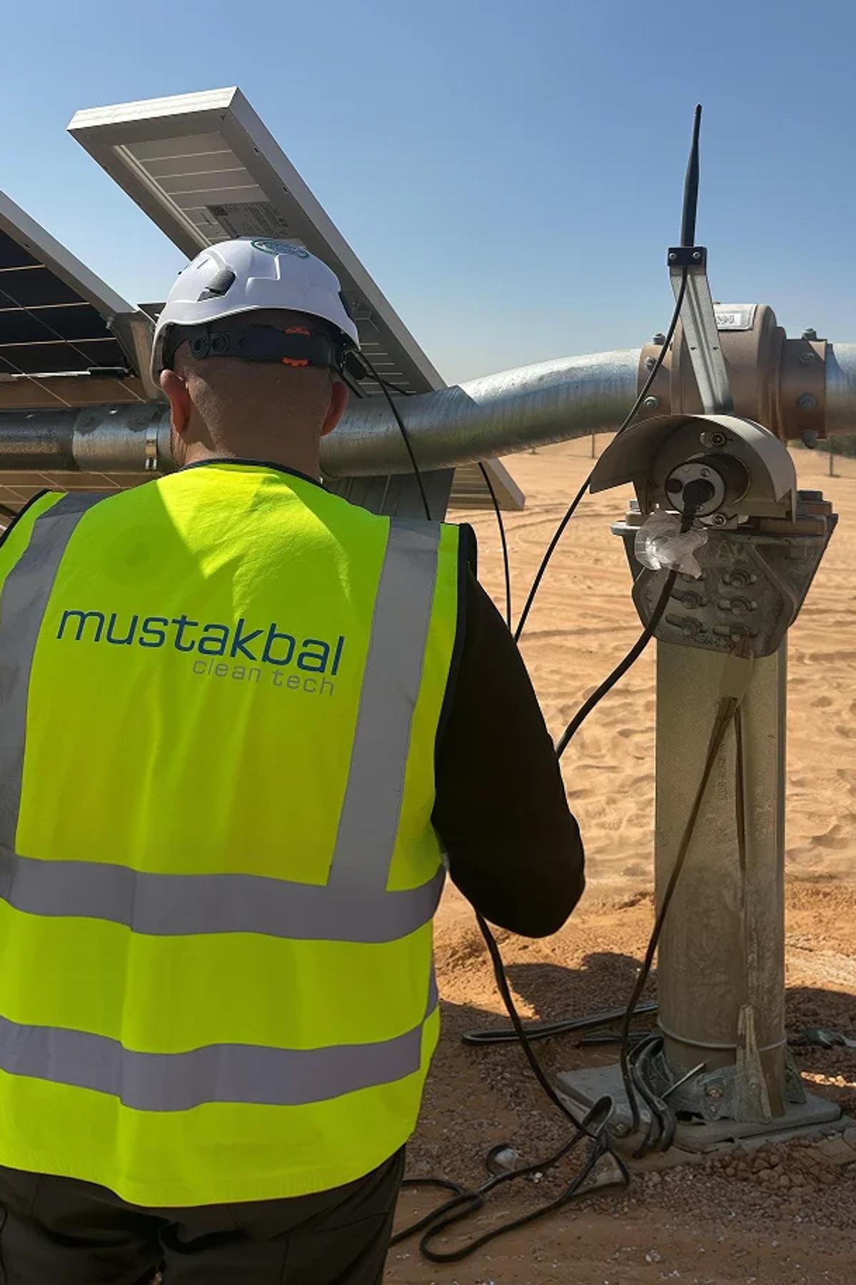 Mustakbal Clean Tech technician performing maintenance on solar panel infrastructure