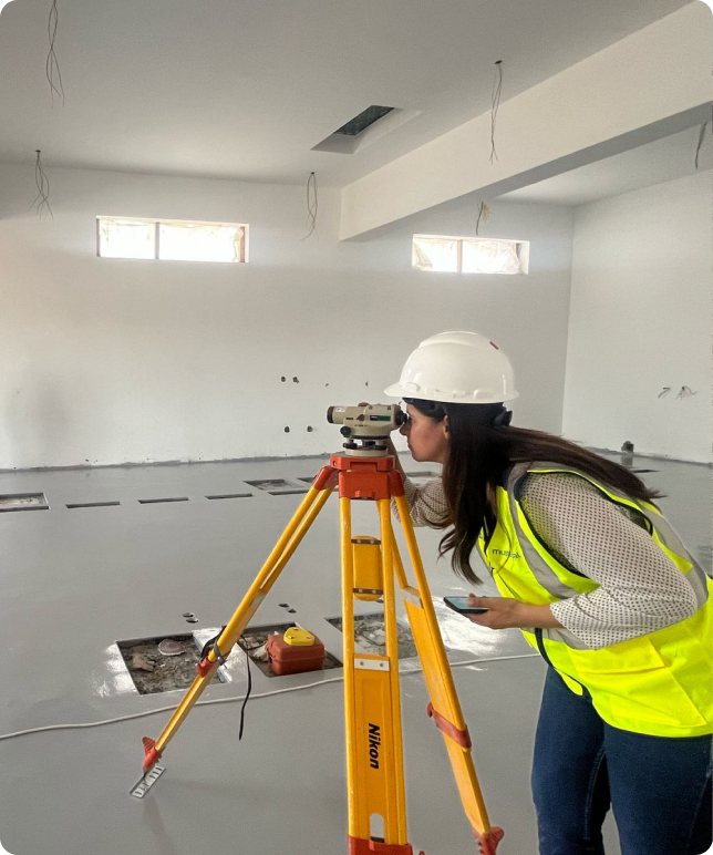 Engineer using a surveying level on a construction site