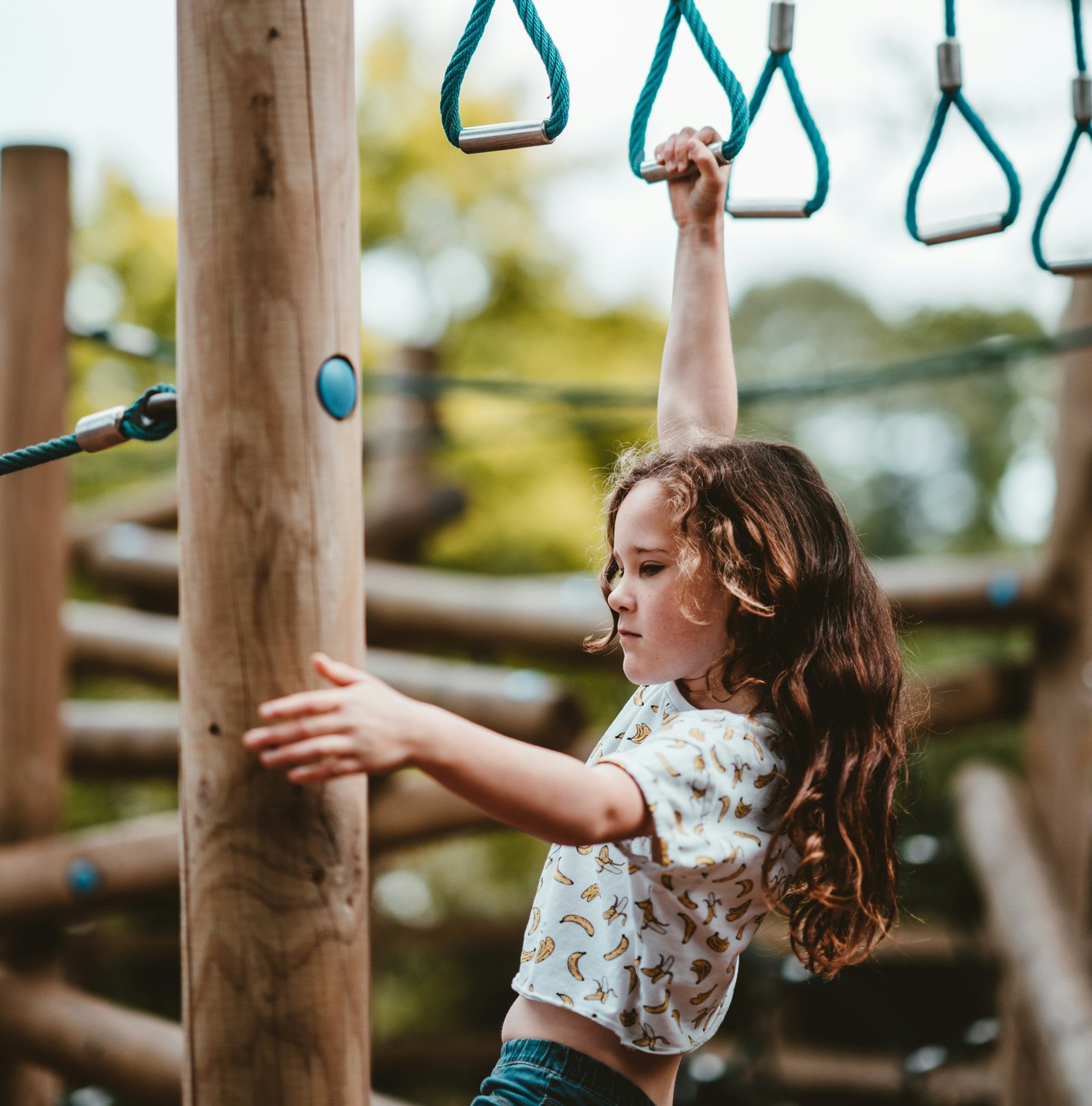 Child playing on a wooden playground