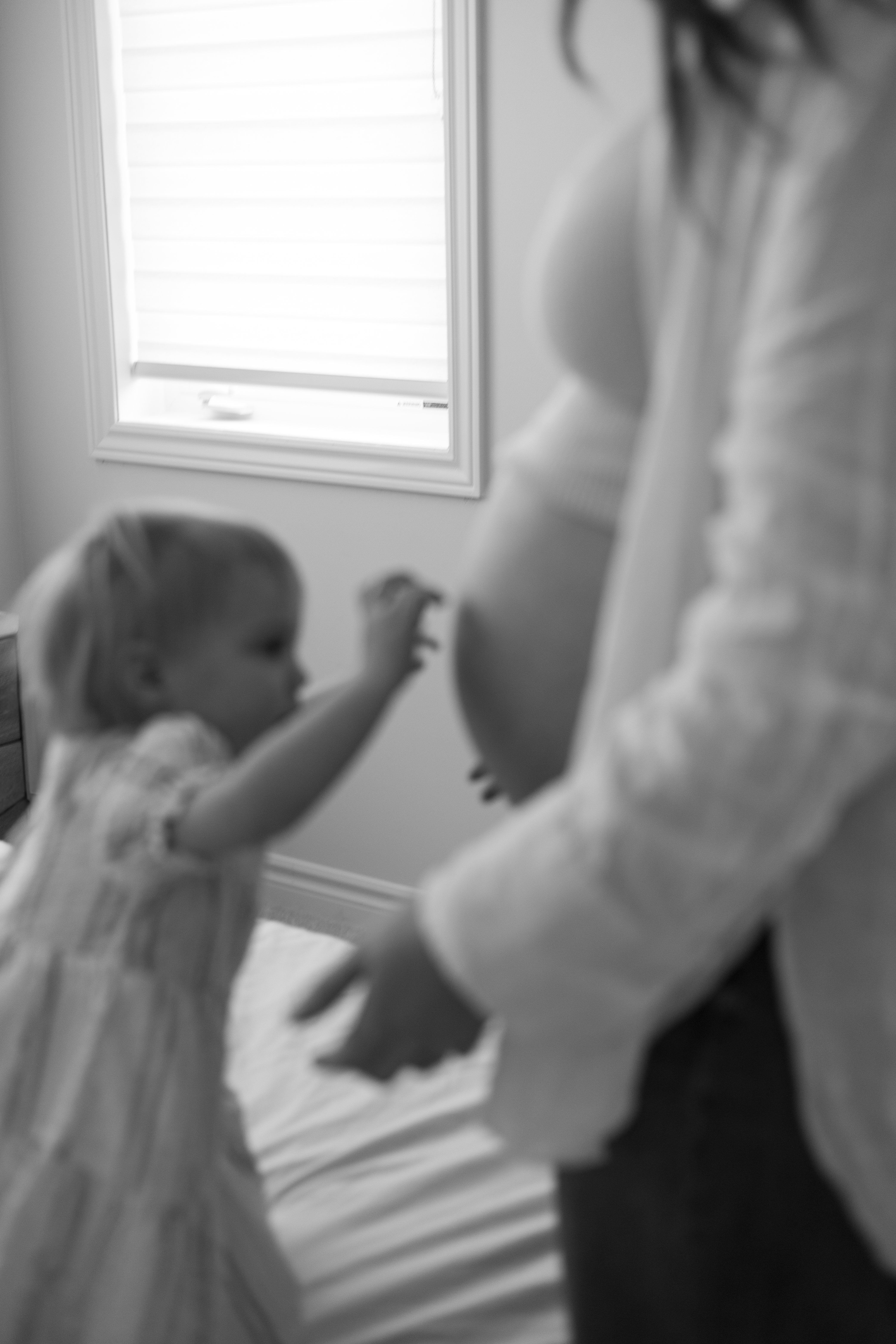 toddler touching moms baby bump - Newmarket Family Photographer