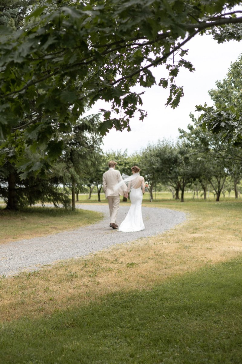Bride and Groom walking in the distance at Kurtz Orchards Niagara-on-the-Lake 