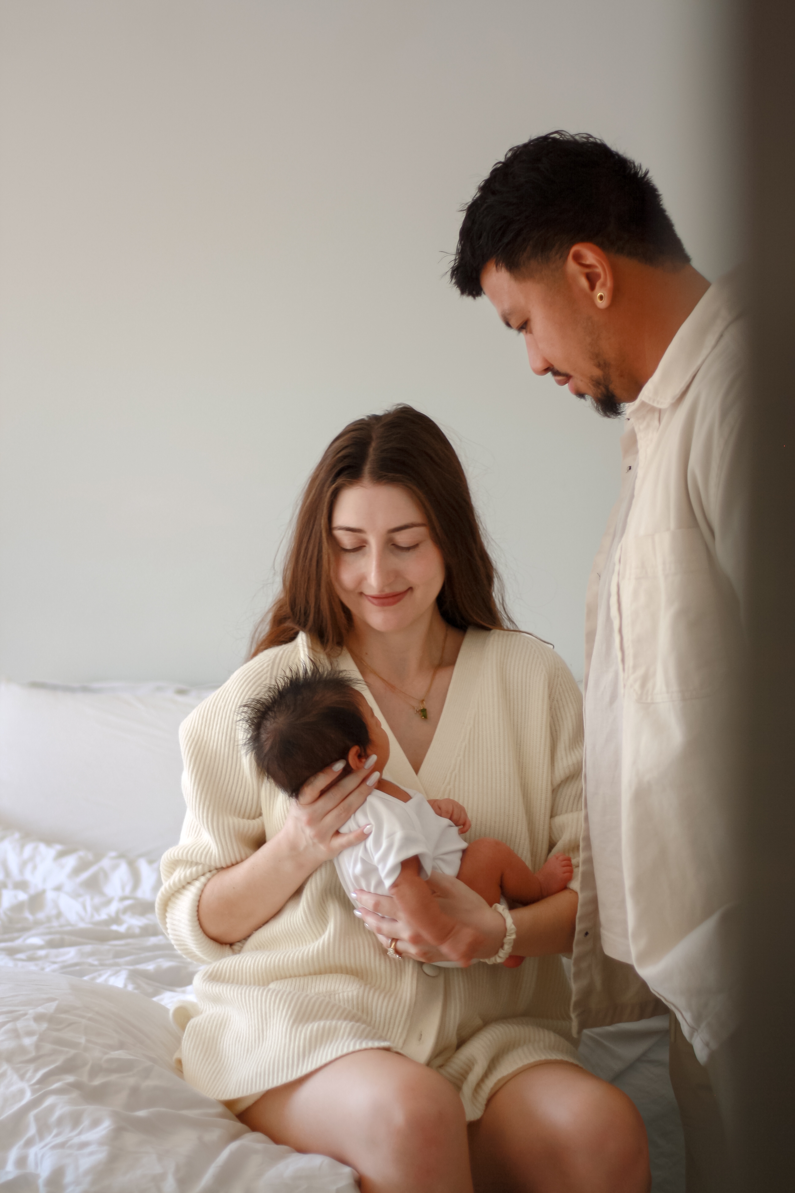 couple looking lovingly at their newborn baby - Newborn Photography