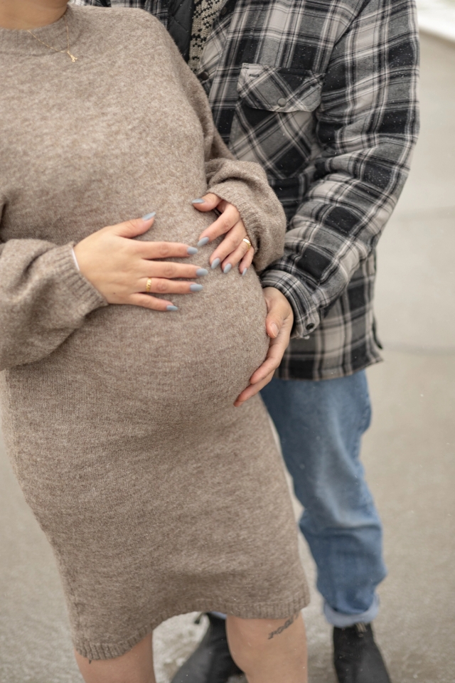 Close up of pregnant woman holding baby belly during a maternity photoshoot.