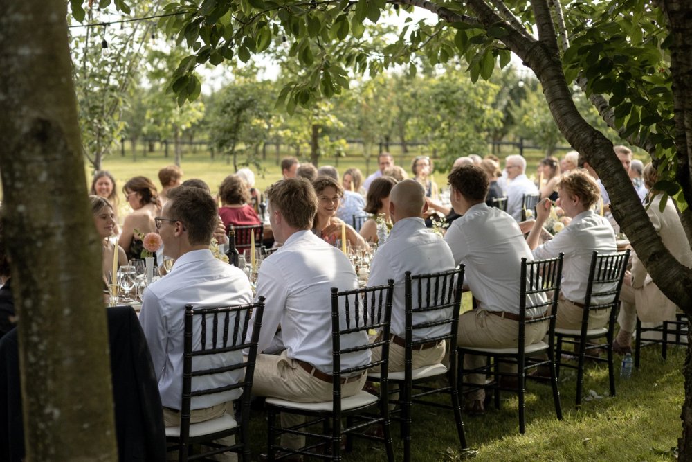 Candid moment of groomsmen during Kurtz Orchards wedding reception
