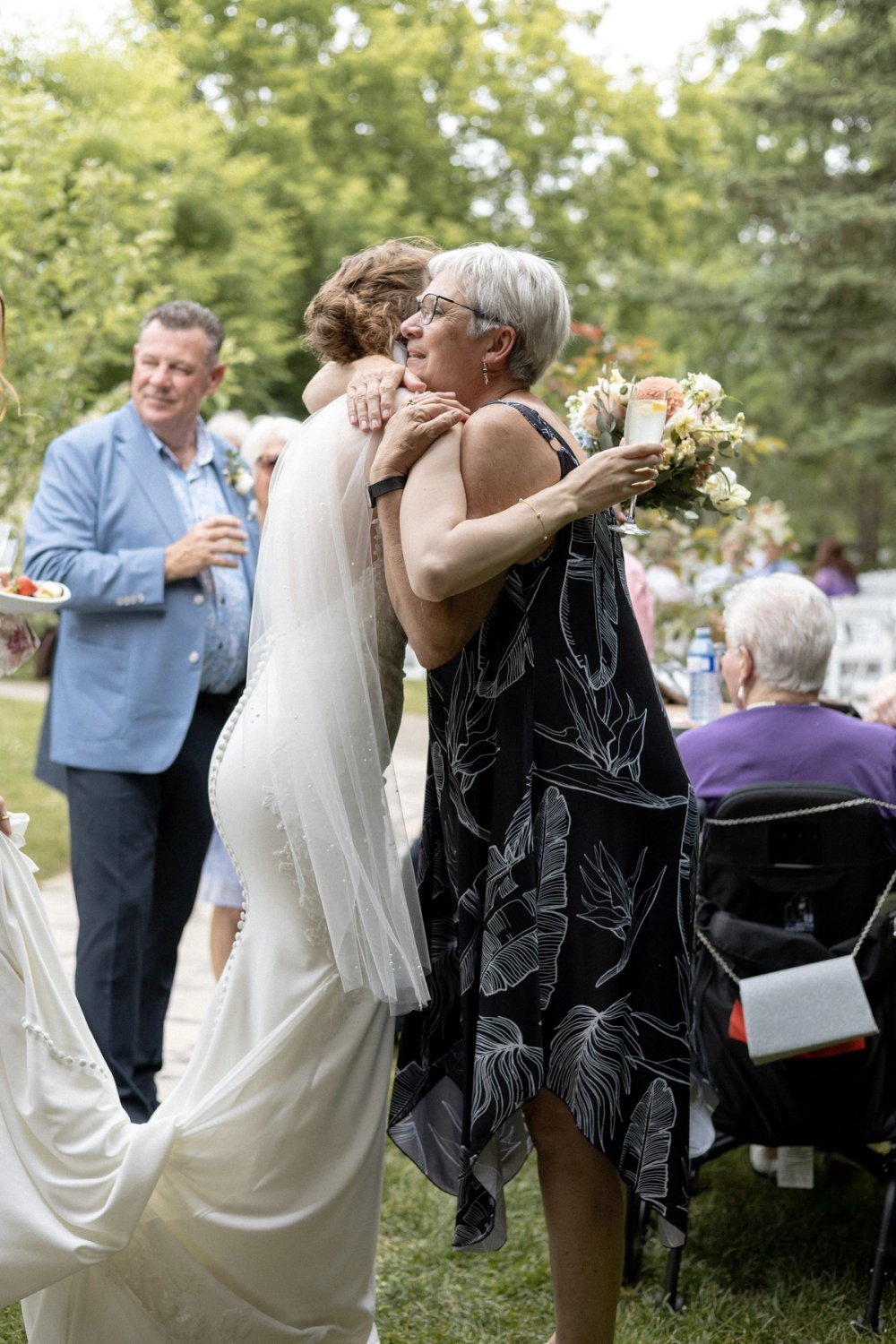 bride hugging family member during cocktail reception